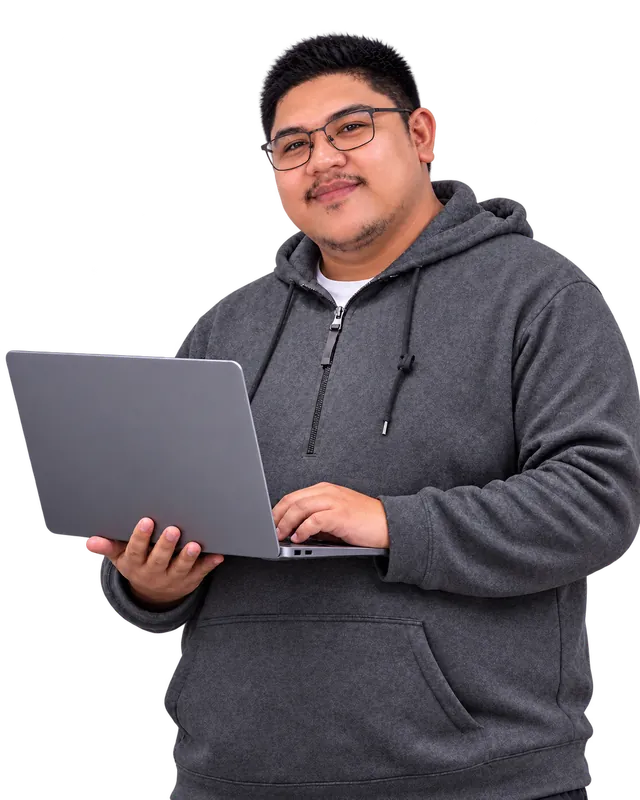 Jhonsent Marilao wearing glasses and a gray hoodie, smiling while holding an open laptop